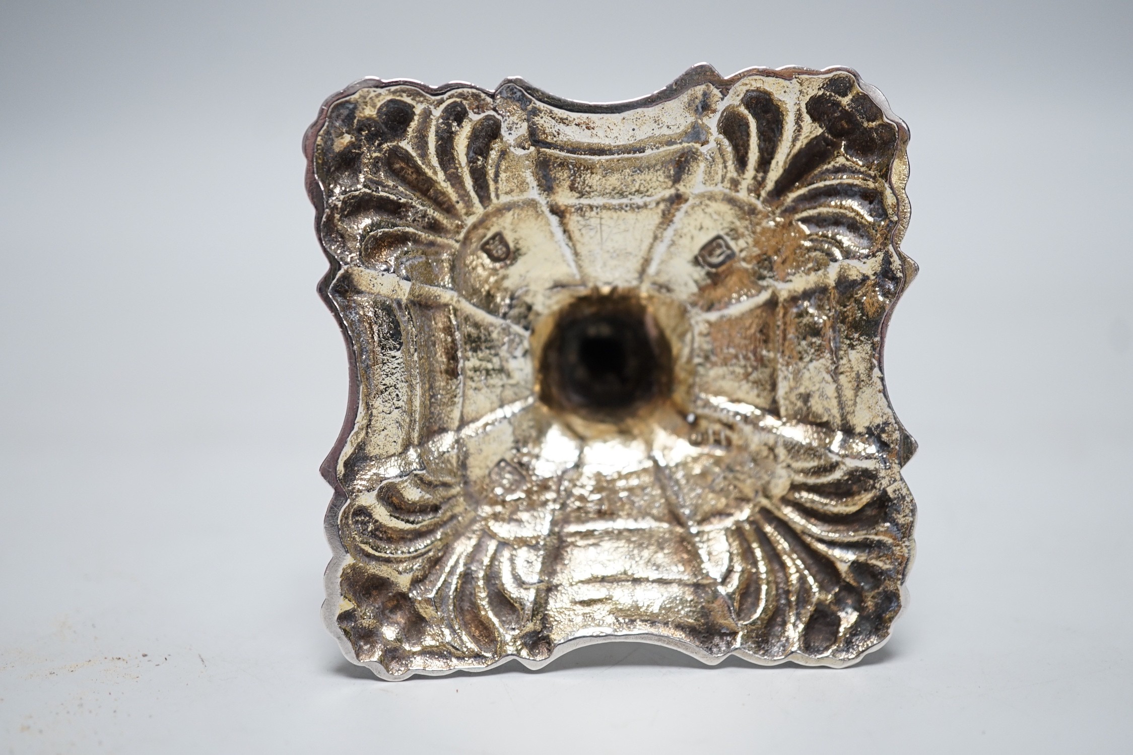 A George III cast silver taper stick, with turned knopped stem and engraved crest, maker, JH, London, 1764, 13.3cm, 4.7oz